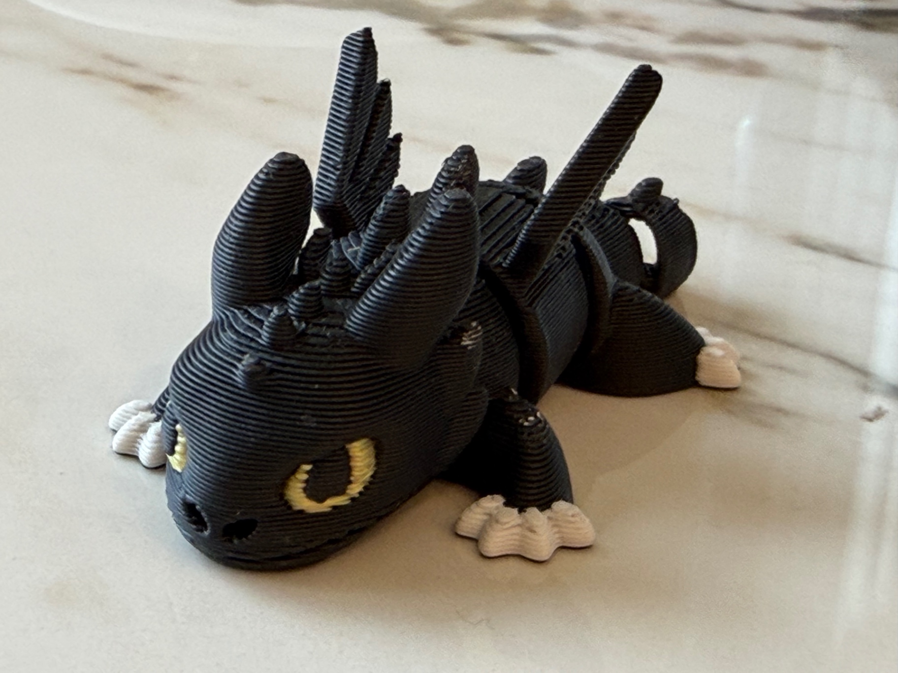 Night Dragon — Glossy black flexi dragon with golden eyes