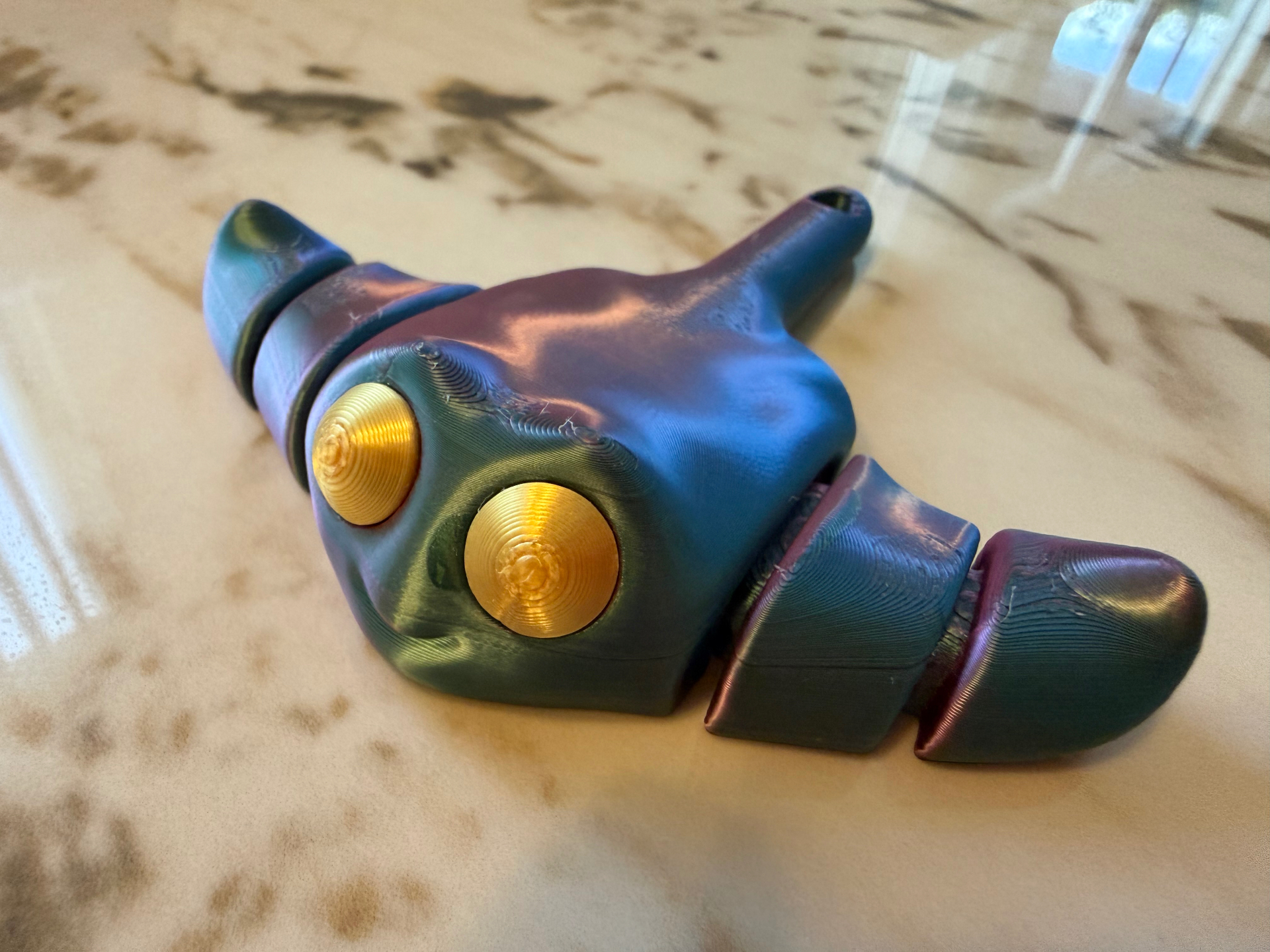 Cosmic Critter — Color-shift articulated buddy with big golden eyes