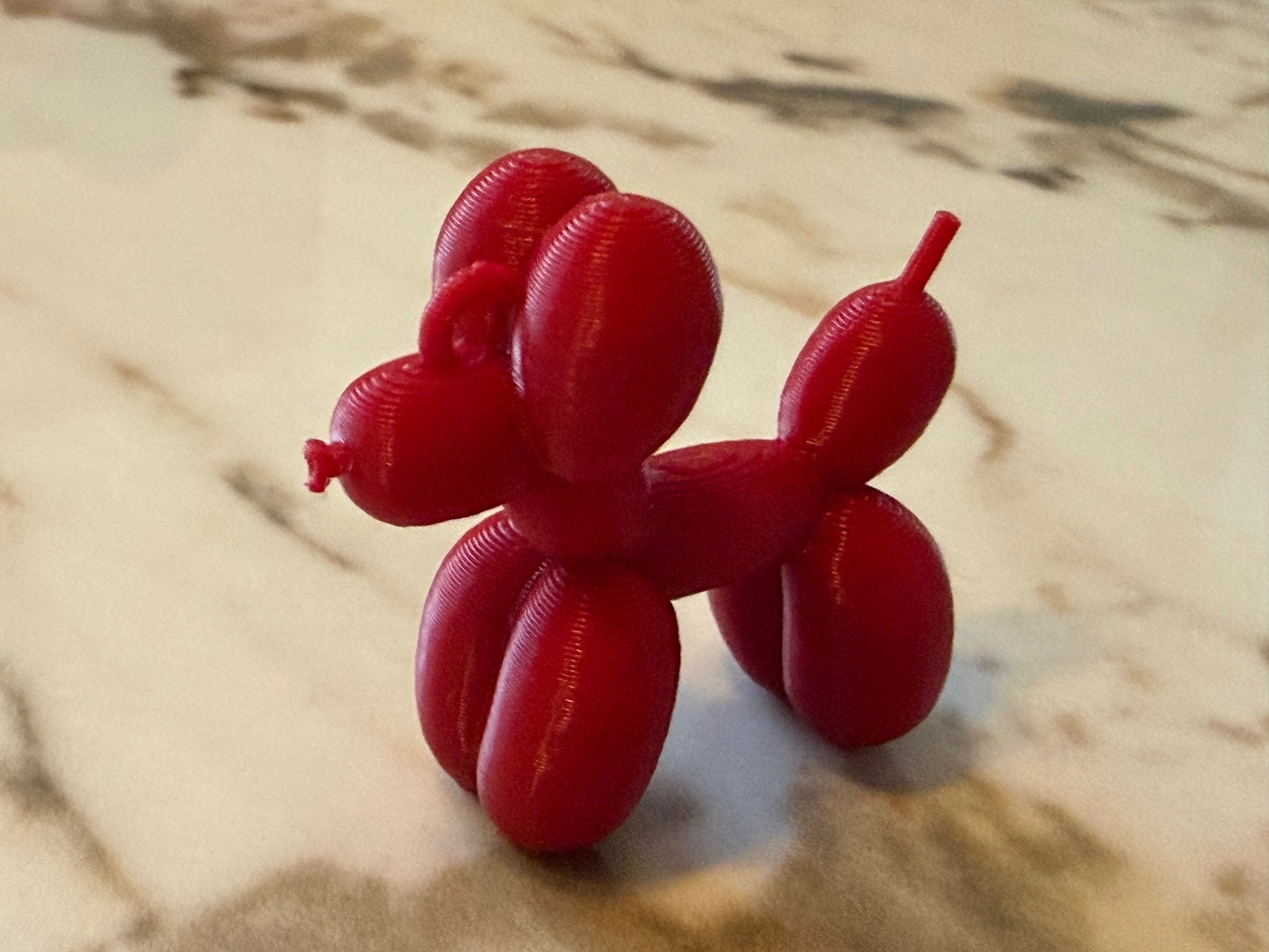 Balloon Pup — Glossy red balloon-style pup ready to play