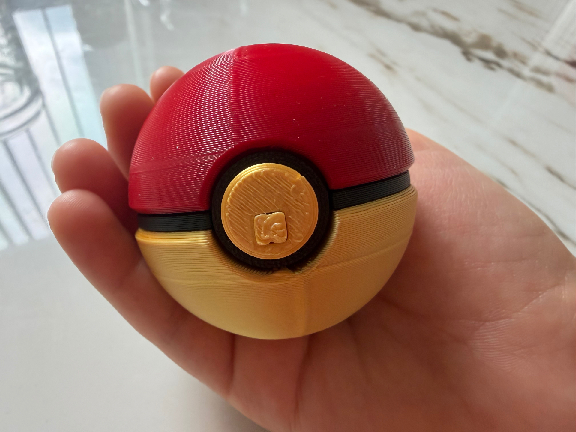 Catch Ball — Palm-size red and gold ball that pops open